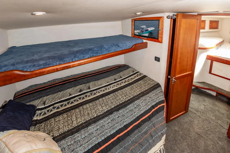Sea Horse Yacht Photos Pics Interior of 1994 Custom Carolina 43 Blackwell Convertible with cozy bunk beds and wooden accents.
