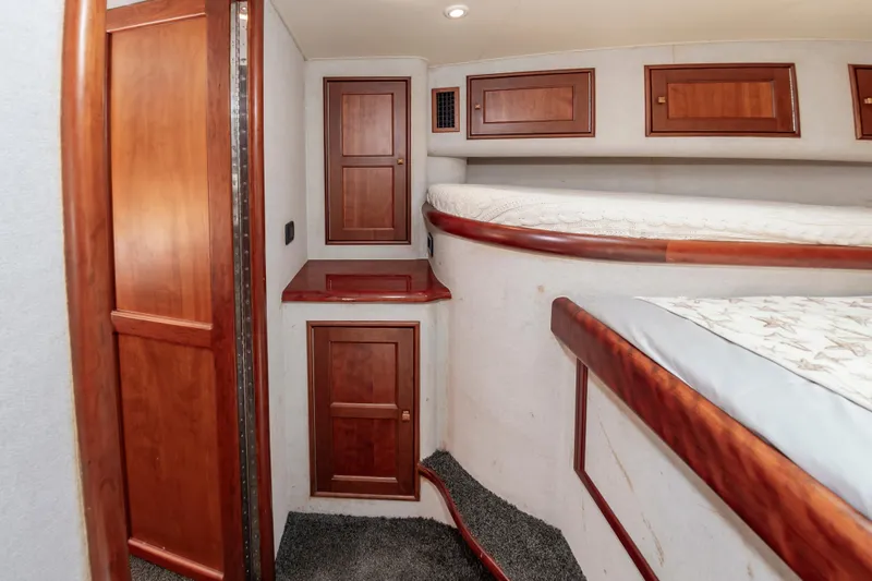 Sea Horse Yacht Photos Pics Interior of 1994 Custom Carolina 43 Blackwell Convertible with wooden cabinetry and cozy sleeping area.
