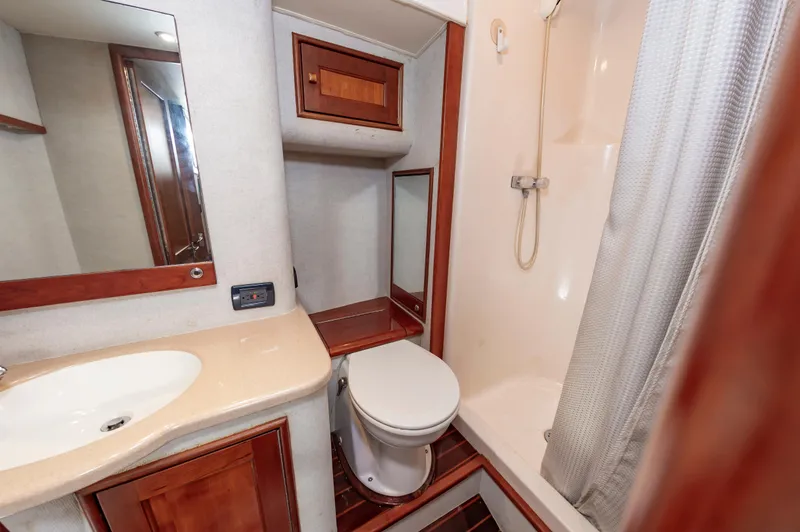 Sea Horse Yacht Photos Pics Bathroom interior of 1994 Custom Carolina 43 Blackwell Convertible yacht, featuring shower and sink.