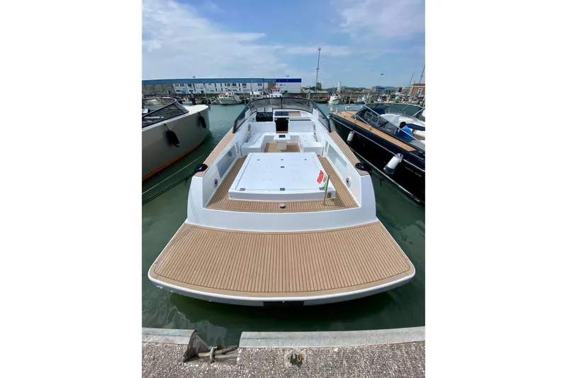  Yacht Photos Pics 2025 VanDutch 48 yacht docked, showcasing sleek design and spacious deck.