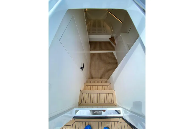  Yacht Photos Pics Interior view of 2025 VanDutch 48 yacht, featuring sleek wooden steps and modern design.