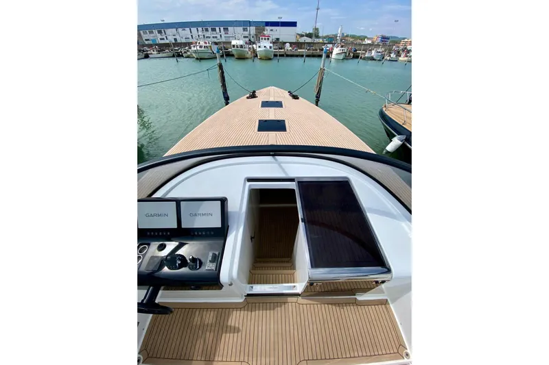  Yacht Photos Pics 2025 VanDutch 48 yacht with Garmin navigation, docked in a marina.