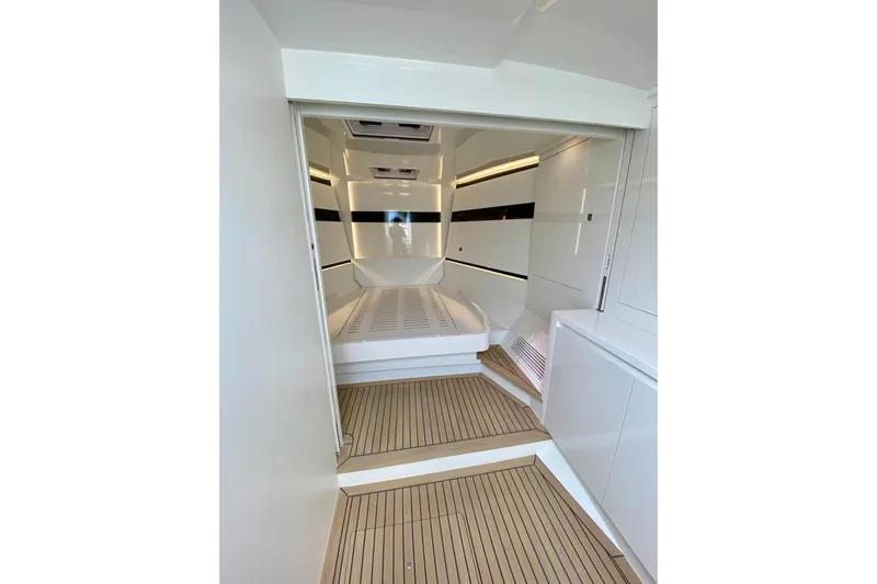  Yacht Photos Pics Interior of 2025 VanDutch 48 yacht, featuring sleek white design and wooden flooring.