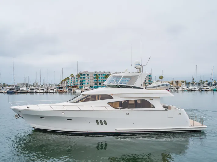 Oceana Yacht Photos Pics 2009 McKinna 60 Pilothouse yacht docked in a marina, with modern buildings in the background.