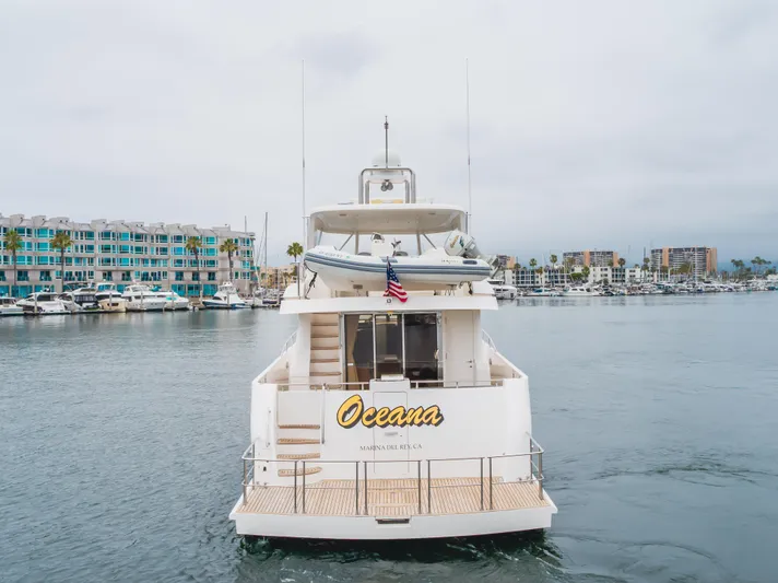 Oceana Yacht Photos Pics 2009 McKinna 60 Pilothouse yacht "Oceana" docked in a marina with waterfront buildings.
