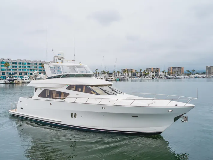 Oceana Yacht Photos Pics 2009 McKinna 60 Pilothouse yacht cruising in a marina with modern buildings in the background.