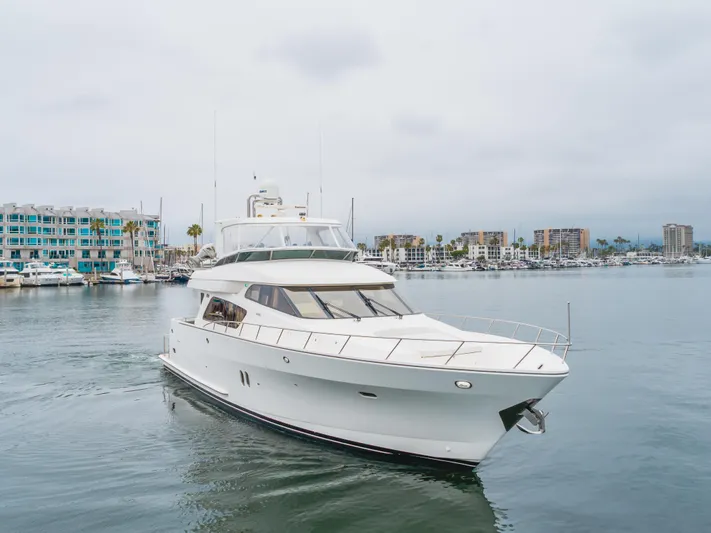 Oceana Yacht Photos Pics 2009 McKinna 60 Pilothouse yacht cruising in a marina with cityscape background.