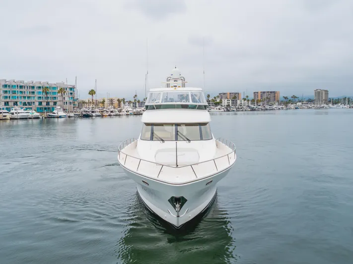 Oceana Yacht Photos Pics 2009 McKinna 60 Pilothouse yacht in marina, calm waters, cityscape background.