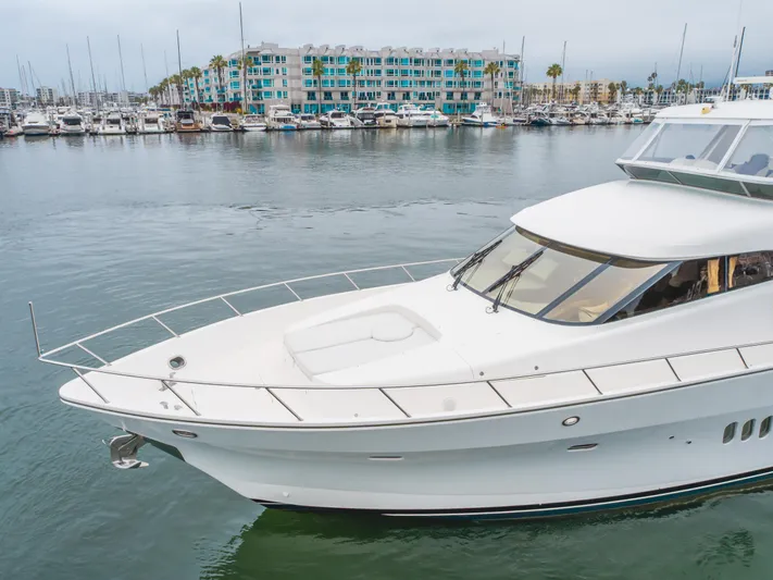 Oceana Yacht Photos Pics 2009 McKinna 60 Pilothouse yacht docked in a marina, with waterfront buildings in the background.