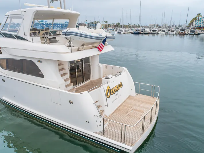 Oceana Yacht Photos Pics 2009 McKinna 60 Pilothouse yacht docked in marina, featuring spacious deck and tender boat.