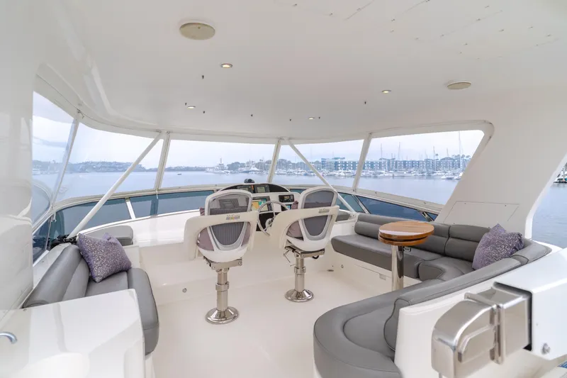 Oceana Yacht Photos Pics Luxurious 2009 McKinna 60 Pilothouse yacht interior with seating and helm, overlooking marina.