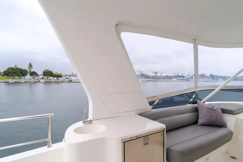 Oceana Yacht Photos Pics Luxurious 2009 McKinna 60 Pilothouse yacht interior with plush seating and scenic waterfront view.