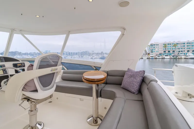 Oceana Yacht Photos Pics Luxurious 2009 McKinna 60 Pilothouse yacht interior with plush seating and marina view.