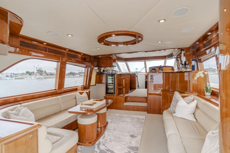 Oceana Yacht Photos Pics Luxurious interior of 2009 McKinna 60 Pilothouse yacht with elegant wood finishes and plush seating.