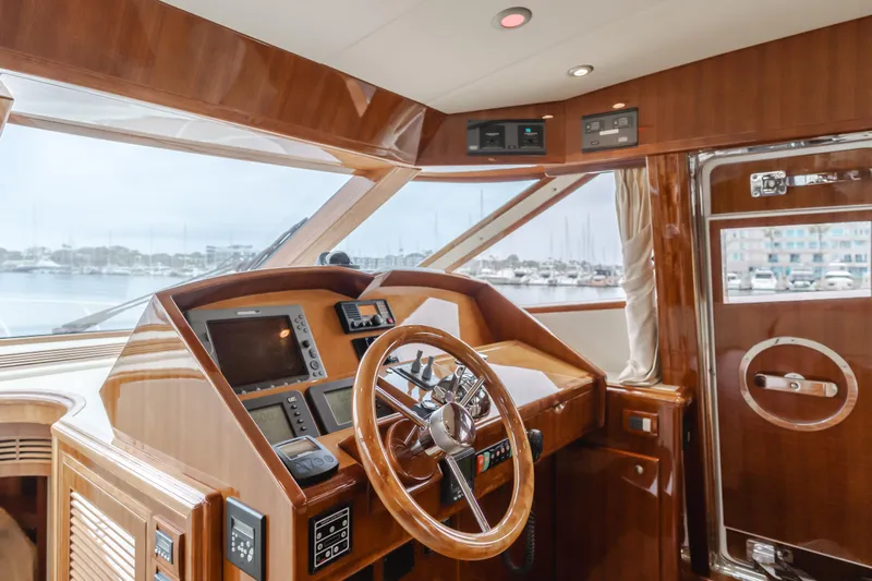 Oceana Yacht Photos Pics Luxurious 2009 McKinna 60 Pilothouse yacht interior with polished wood helm and modern navigation equipment.
