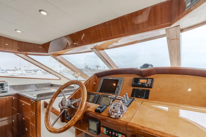 Oceana Yacht Photos Pics Pilothouse interior of 2009 McKinna 60 yacht, featuring wooden helm and navigation equipment.