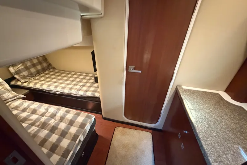 Dorita Yacht Photos Pics Interior of 2012 Monterey 400 Sport Yacht with twin beds and wooden cabinetry.