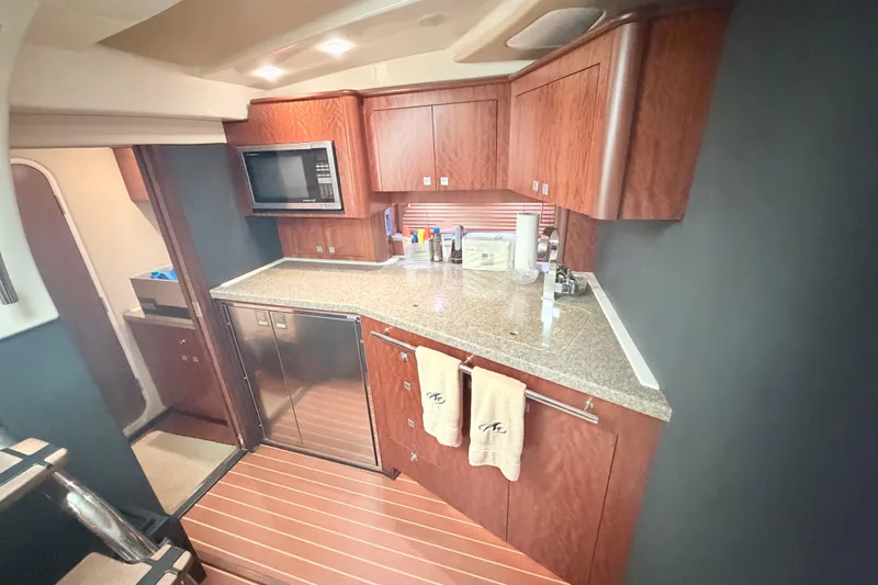 Dorita Yacht Photos Pics Luxurious kitchen interior of 2012 Monterey 400 Sport Yacht with wood cabinetry and modern appliances.