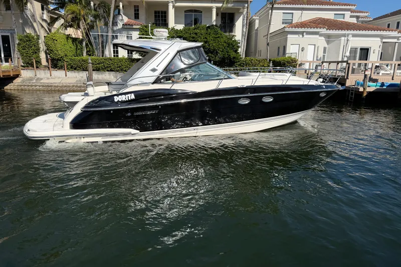 Dorita Yacht Photos Pics 2012 Monterey 400 Sport Yacht cruising near waterfront homes.