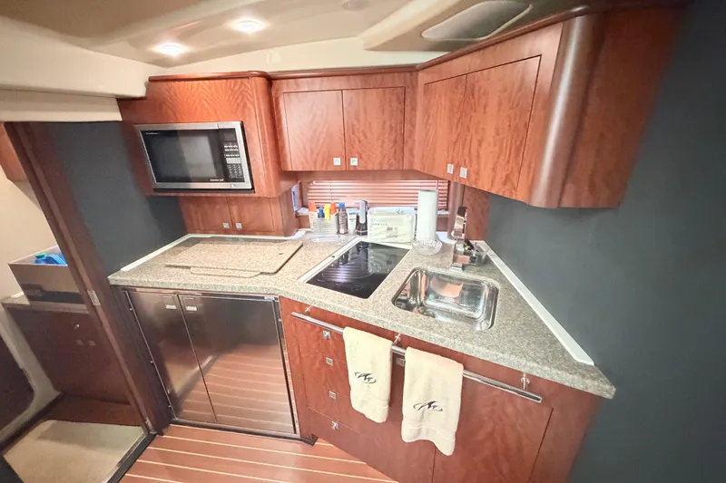 Dorita Yacht Photos Pics Luxurious kitchen in 2012 Monterey 400 Sport Yacht with wood cabinets and modern appliances.