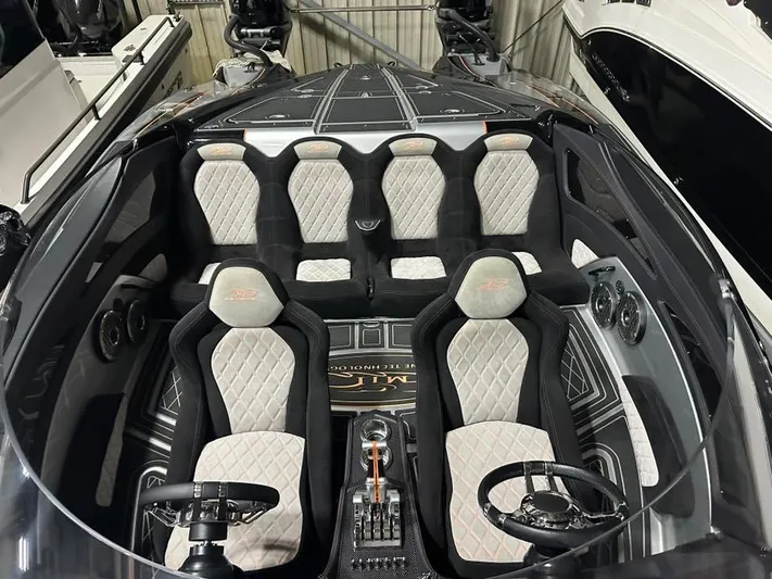  Yacht Photos Pics Luxurious interior of a 2018 MTI 340X boat with quilted seats and dual steering wheels.