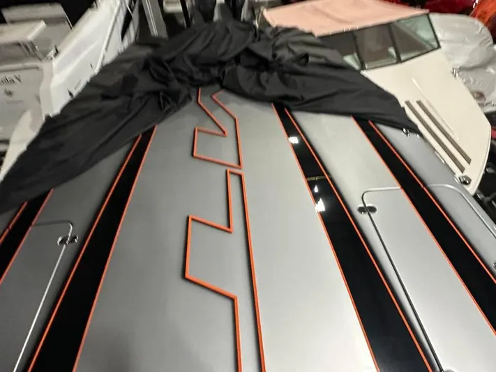  Yacht Photos Pics 2018 MTI 340X boat with sleek black and orange design, partially covered.