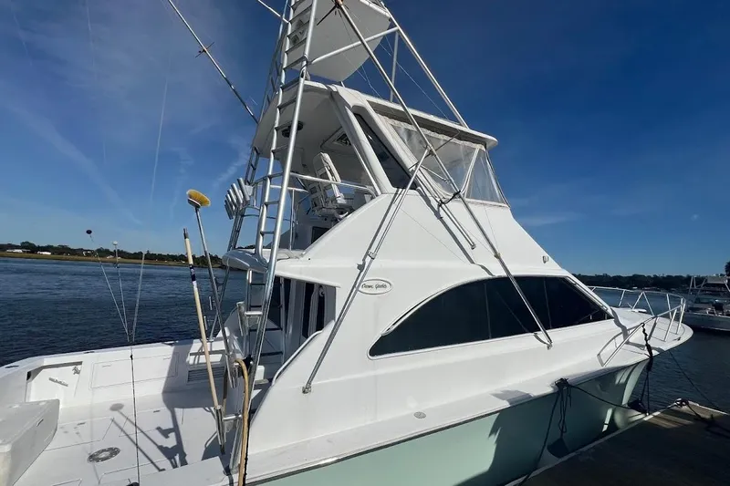 Top Pryority Yacht Photos Pics 1996 Ocean Yachts 48 Super Sport docked, showcasing sleek design and fishing equipment.