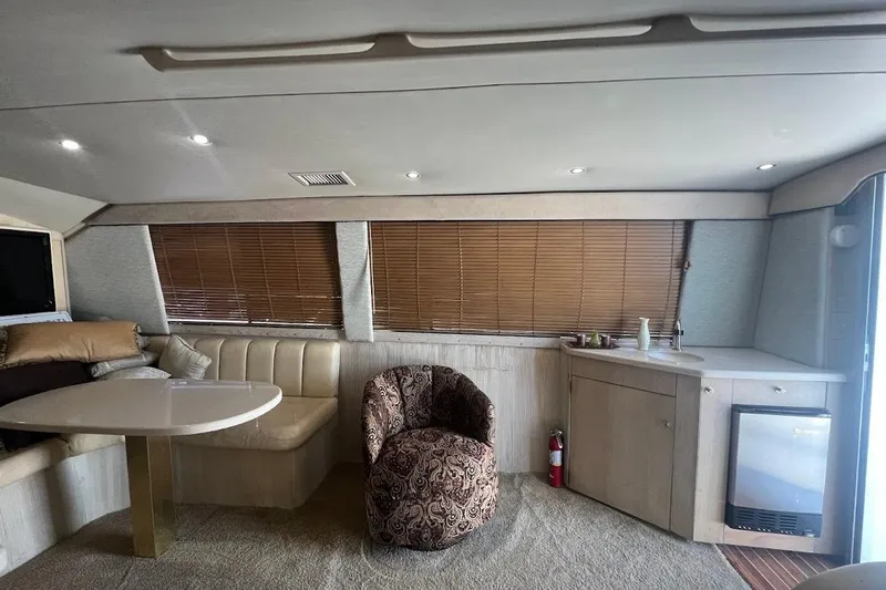Top Pryority Yacht Photos Pics Interior of 1996 Ocean Yachts 48 Super Sport with seating, table, and kitchenette.