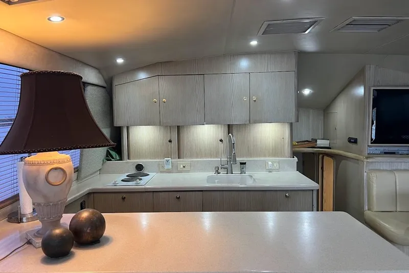 Top Pryority Yacht Photos Pics Luxurious 1996 Ocean Yachts 48 Super Sport interior with modern kitchen and elegant decor.