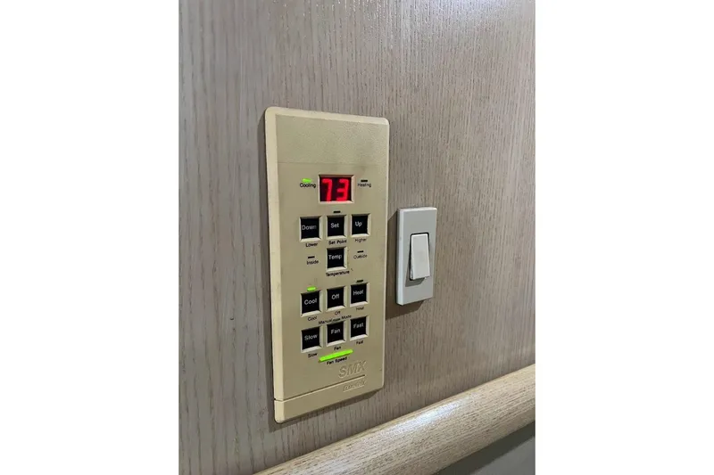 Top Pryority Yacht Photos Pics Control panel on 1996 Ocean Yachts 48 Super Sport, displaying temperature settings.