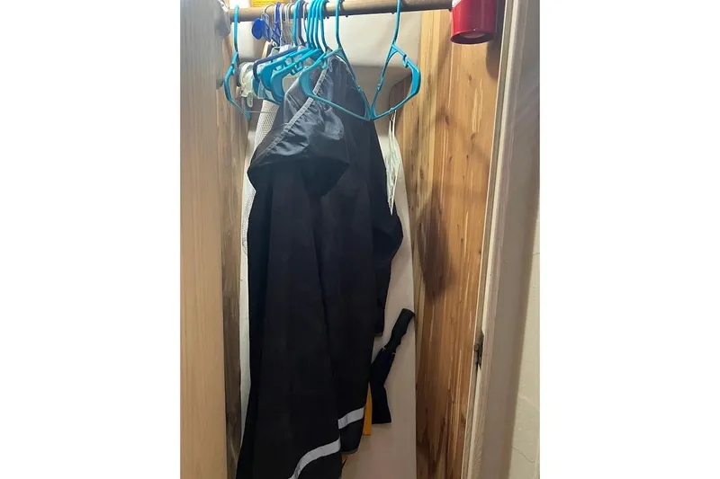 Top Pryority Yacht Photos Pics Closet with clothes on hangers inside 1996 Ocean Yachts 48 Super Sport.