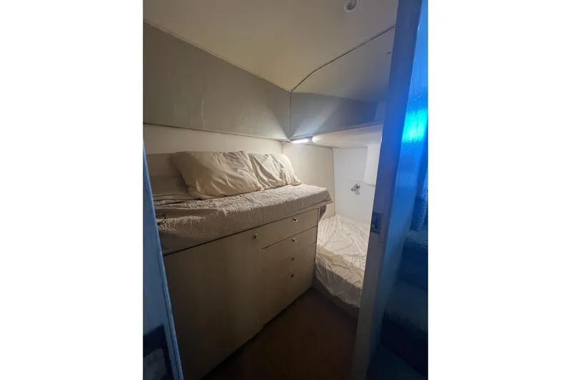 Top Pryority Yacht Photos Pics 1996 Ocean Yachts 48 Super Sport cabin interior with bed and storage drawers.