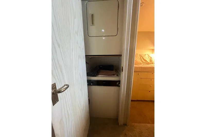 Top Pryority Yacht Photos Pics 1996 Ocean Yachts 48 Super Sport interior with compact laundry area.