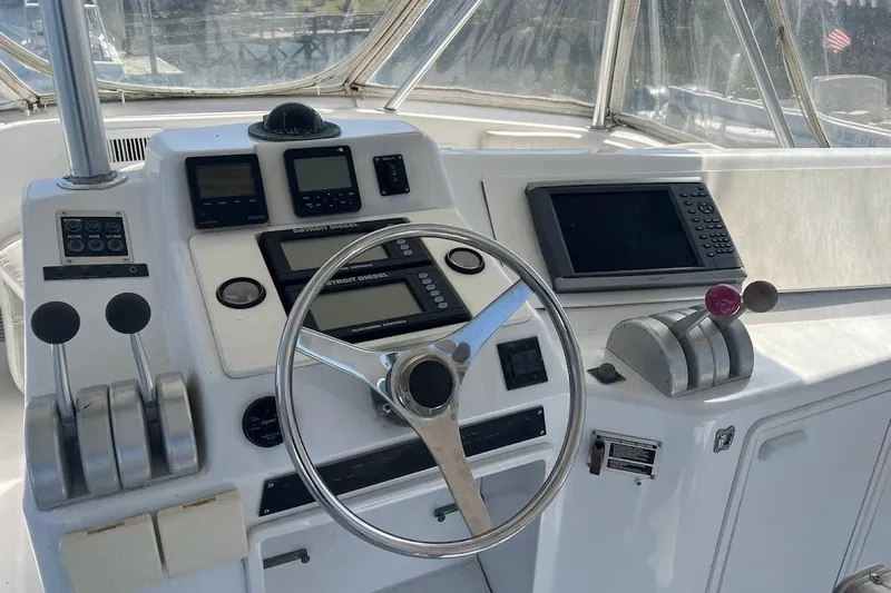 Top Pryority Yacht Photos Pics 1996 Ocean Yachts 48 Super Sport helm with steering wheel and navigation controls.