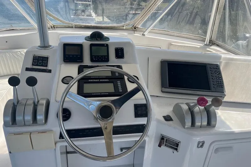 Top Pryority Yacht Photos Pics Cockpit of 1996 Ocean Yachts 48 Super Sport with steering wheel and navigation controls.