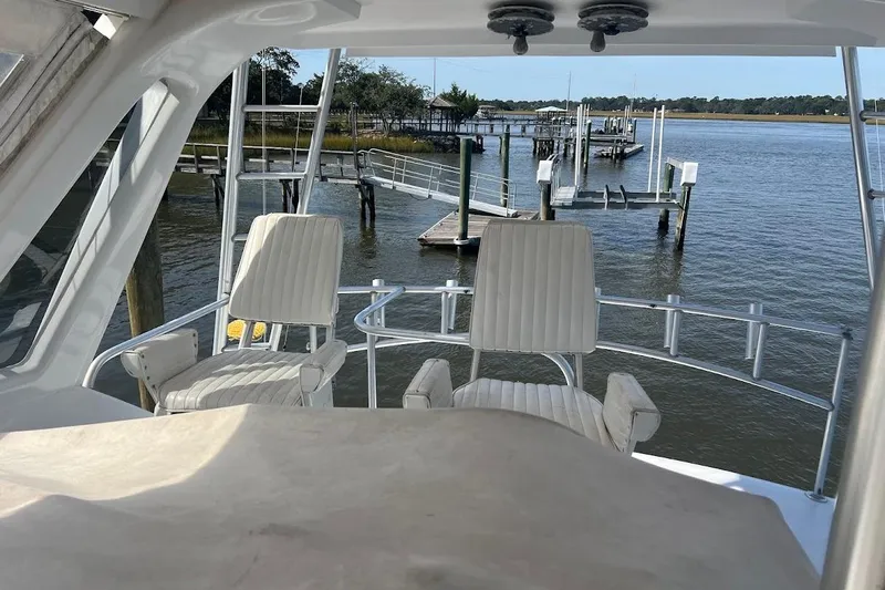 Top Pryority Yacht Photos Pics Flybridge view of 1996 Ocean Yachts 48 Super Sport, overlooking a serene marina.