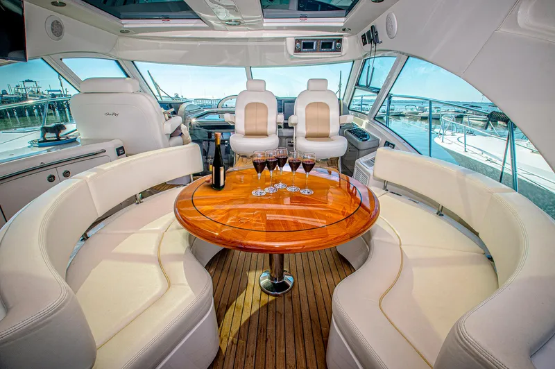 At's Ahmibote V Yacht Photos Pics Luxurious interior of 2011 Sea Ray 580 Sundancer yacht with elegant seating and table.