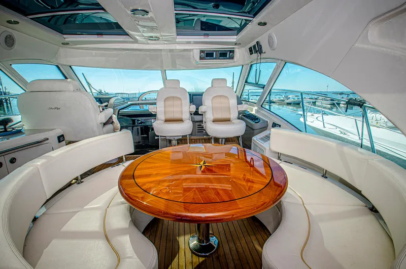At's Ahmibote V Yacht Photos Pics Luxurious interior of 2011 Sea Ray 580 Sundancer yacht with elegant seating and wooden table.