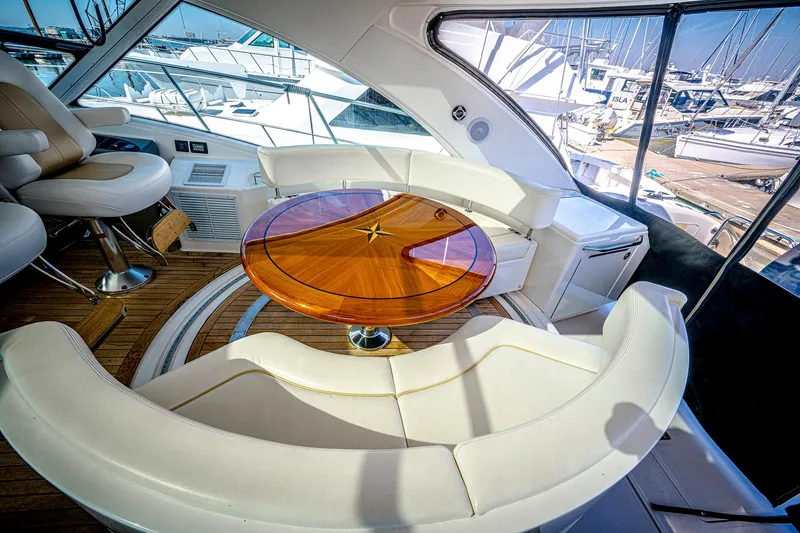 At's Ahmibote V Yacht Photos Pics Luxurious 2011 Sea Ray 580 Sundancer yacht interior with elegant seating and wooden table.