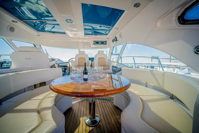At's Ahmibote V Yacht Photos Pics Luxurious 2011 Sea Ray 580 Sundancer yacht interior with elegant seating and table.