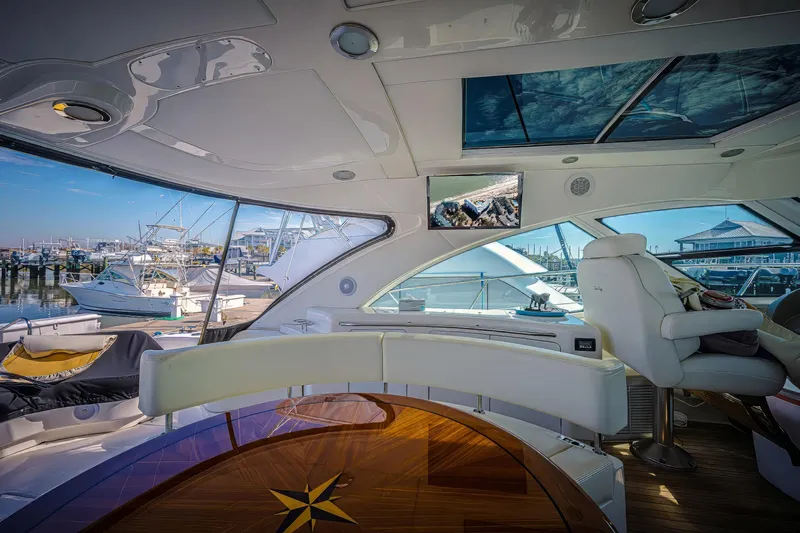 At's Ahmibote V Yacht Photos Pics Luxurious interior of 2011 Sea Ray 580 Sundancer yacht with panoramic windows and elegant seating.