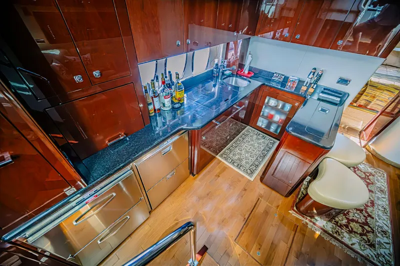 At's Ahmibote V Yacht Photos Pics Luxurious 2011 Sea Ray 580 Sundancer yacht kitchen with modern amenities and elegant wood finishes.