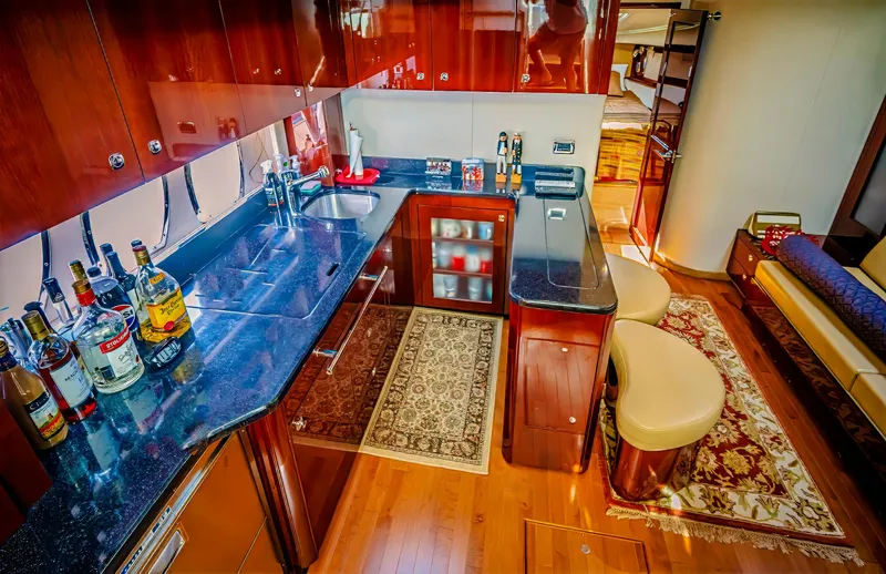 At's Ahmibote V Yacht Photos Pics Luxurious 2011 Sea Ray 580 Sundancer yacht interior with elegant kitchen and seating area.