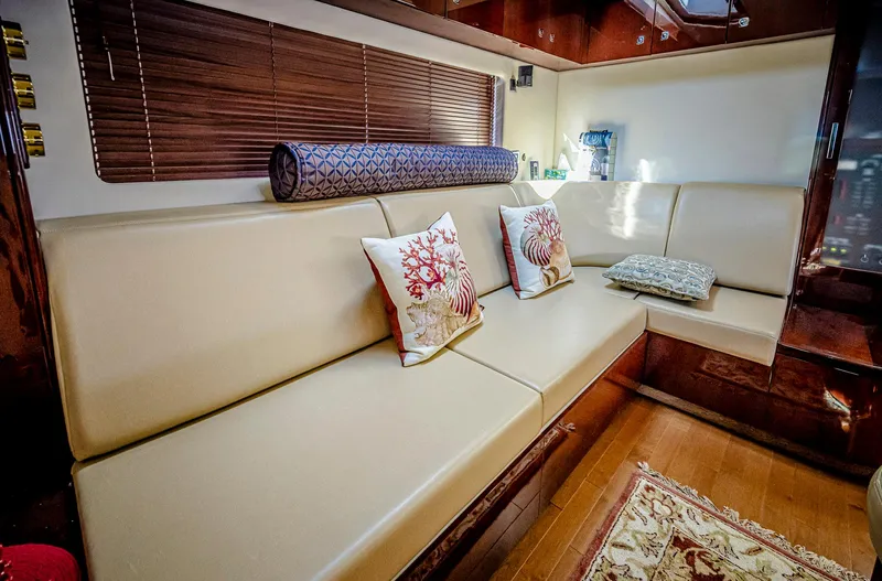 At's Ahmibote V Yacht Photos Pics Luxurious interior of 2011 Sea Ray 580 Sundancer yacht with beige seating and decorative pillows.