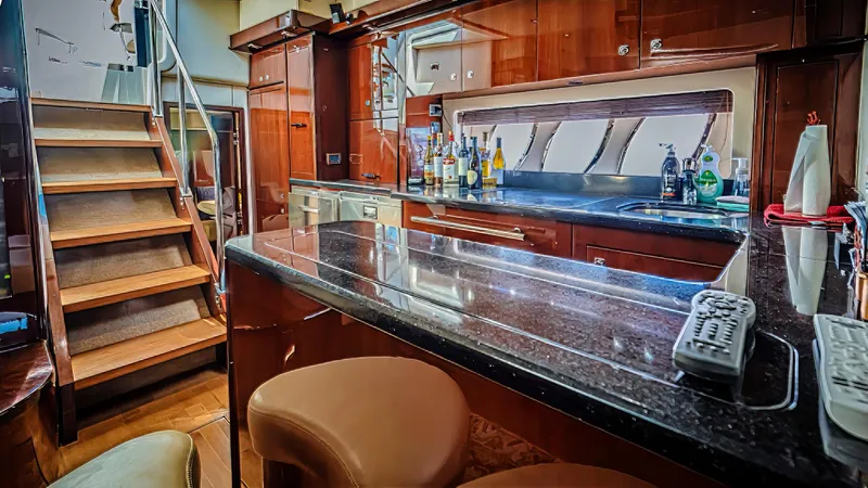 At's Ahmibote V Yacht Photos Pics Luxurious interior of 2011 Sea Ray 580 Sundancer yacht with elegant wood finishes and modern amenities.