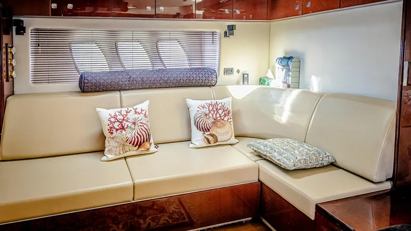 At's Ahmibote V Yacht Photos Pics Luxurious interior of 2011 Sea Ray 580 Sundancer yacht with beige seating and decorative pillows.