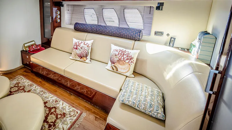 At's Ahmibote V Yacht Photos Pics Luxurious interior of 2011 Sea Ray 580 Sundancer yacht with elegant seating and decorative pillows.