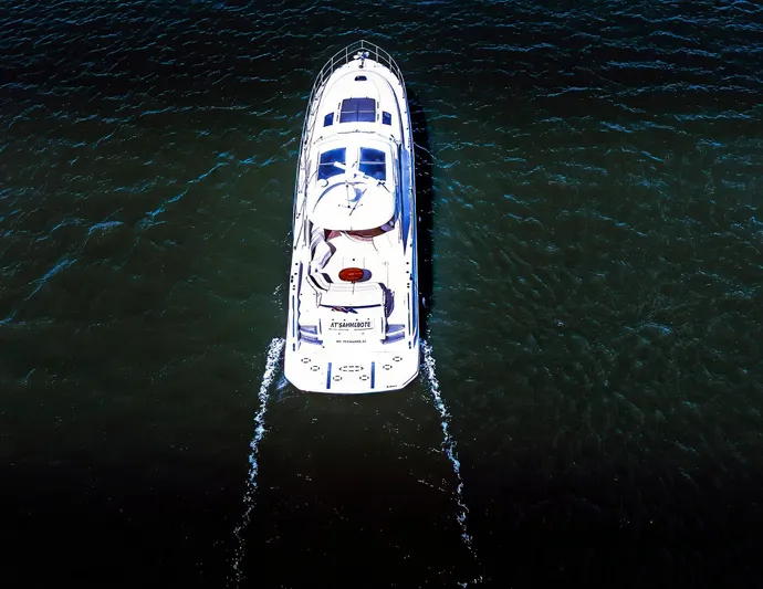 At's Ahmibote V Yacht Photos Pics Aerial view of 2011 Sea Ray 580 Sundancer yacht cruising on open water.