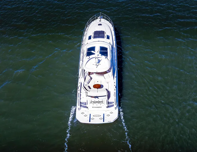 At's Ahmibote V Yacht Photos Pics Aerial view of 2011 Sea Ray 580 Sundancer yacht cruising on open water.