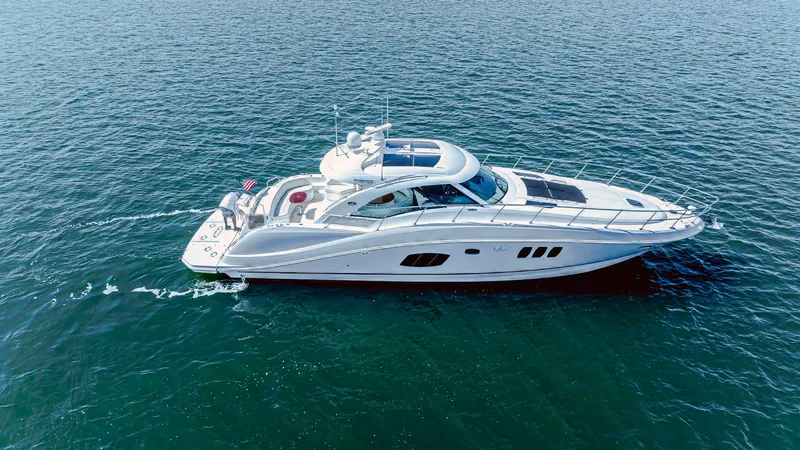 At's Ahmibote V Yacht Photos Pics 2011 Sea Ray 580 Sundancer yacht cruising on open water.